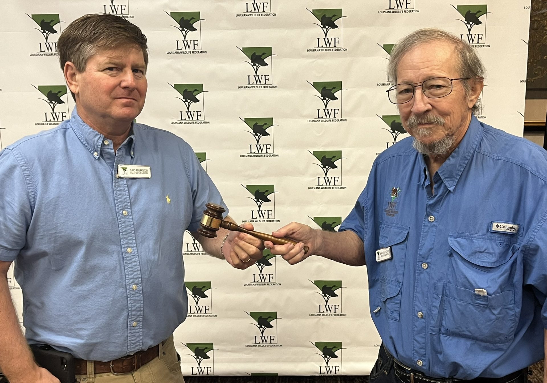 Passing of the gavel from Zac Burson to new president Marty Floyd.